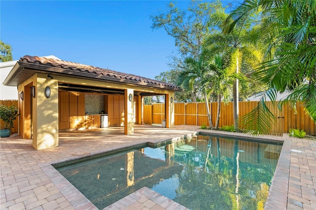 view of pool with an outdoor structure and a patio