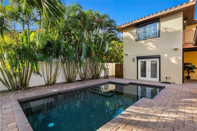 view of pool featuring a patio and french doors