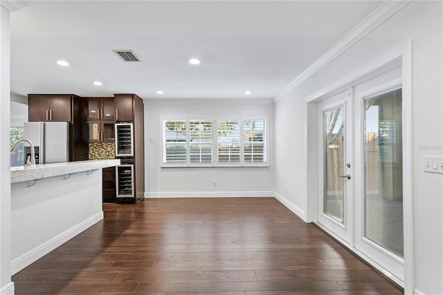 kitchen featuring dark hardwood / wood-style floors, beverage cooler, dark brown cabinetry, stainless steel fridge with ice dispenser, and french doors