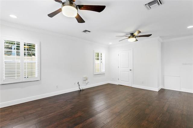 empty room featuring crown molding, plenty of natural light, and dark hardwood / wood-style floors