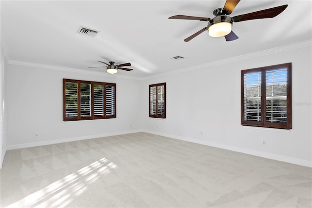 unfurnished room featuring crown molding, light colored carpet, and ceiling fan