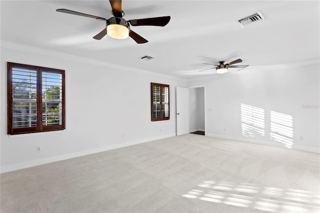 empty room with light carpet, crown molding, and ceiling fan