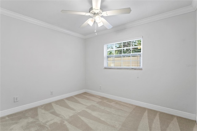 empty room featuring ornamental molding, light colored carpet, and ceiling fan