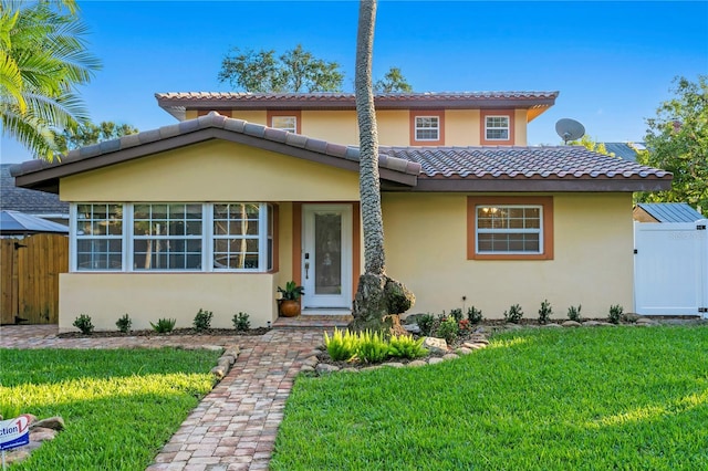 mediterranean / spanish house with a front lawn