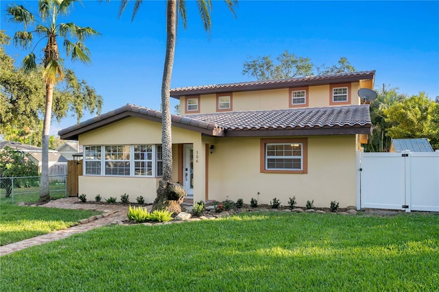 mediterranean / spanish house featuring a front lawn