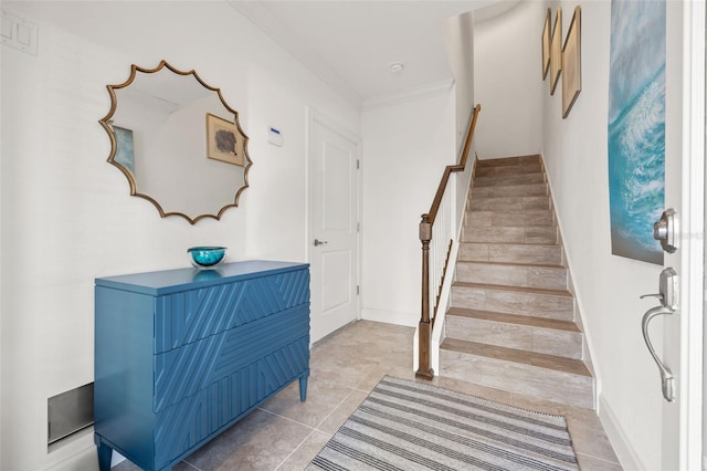 stairway featuring ornamental molding and tile patterned floors