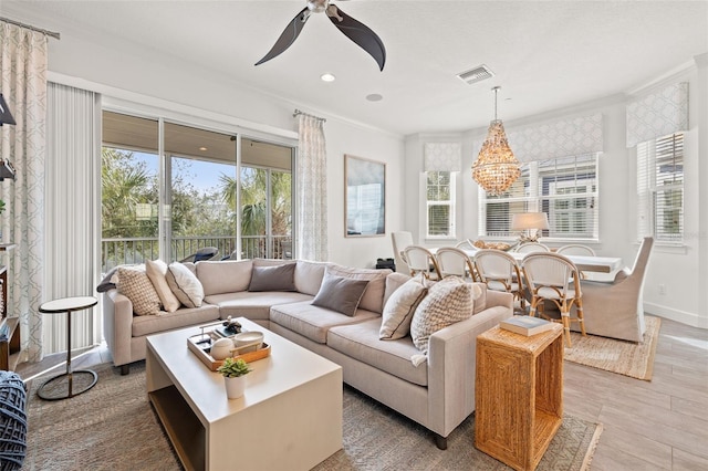 sunroom / solarium with ceiling fan with notable chandelier