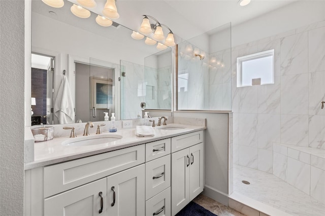 bathroom with vanity and tiled shower