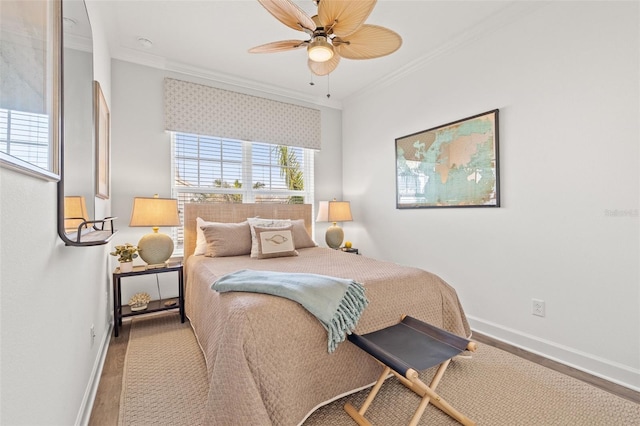 bedroom with crown molding, ceiling fan, and hardwood / wood-style flooring