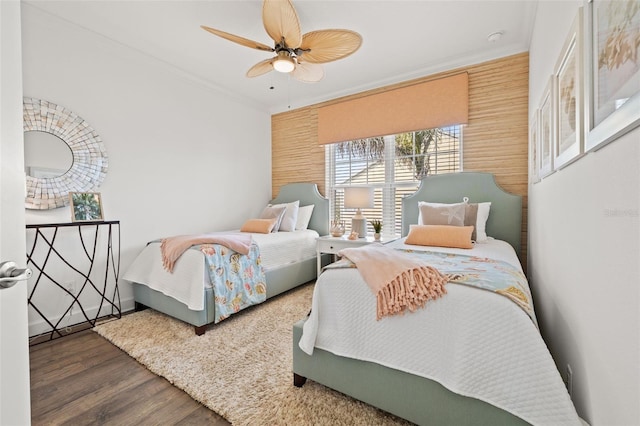 bedroom with crown molding, ceiling fan, and hardwood / wood-style flooring