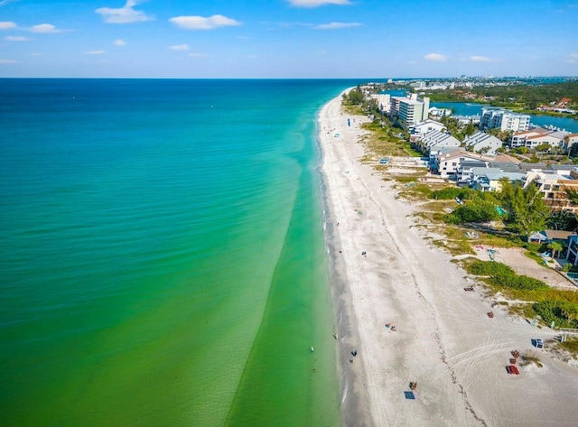 bird's eye view featuring a water view and a beach view