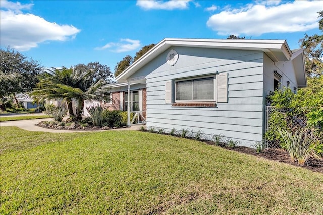 view of side of property with a yard