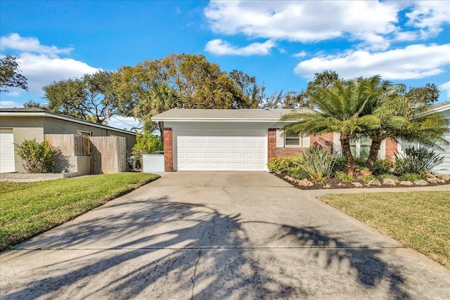 view of front of property featuring a garage and a front yard