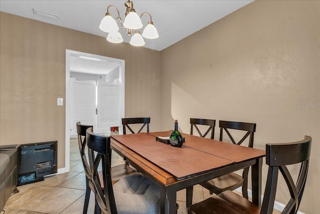 dining room featuring a chandelier and light tile patterned floors