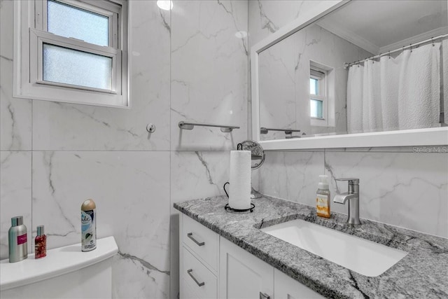 bathroom with vanity, tile walls, curtained shower, and toilet