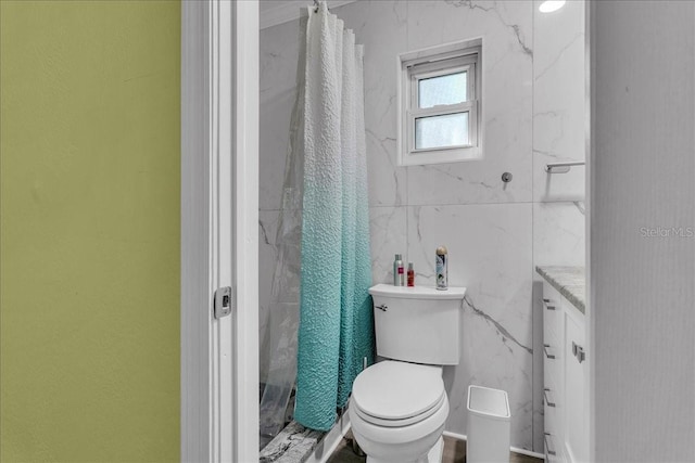 bathroom featuring vanity, tile walls, toilet, and a shower with shower curtain