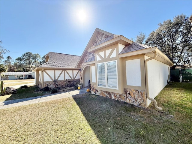 view of side of home with a yard