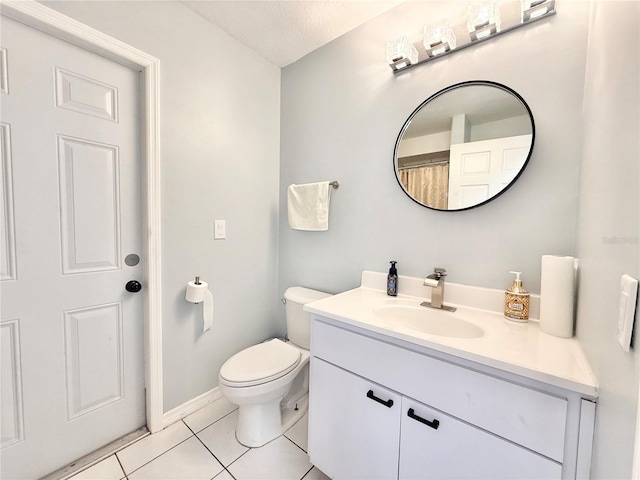 bathroom with vanity, tile patterned floors, and toilet