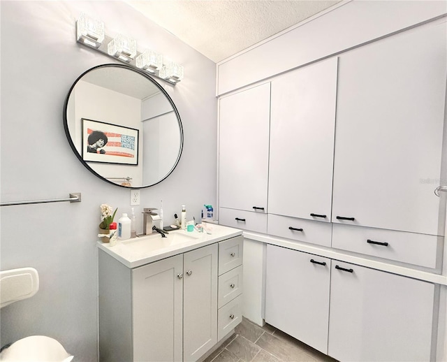 bathroom featuring vanity and a textured ceiling