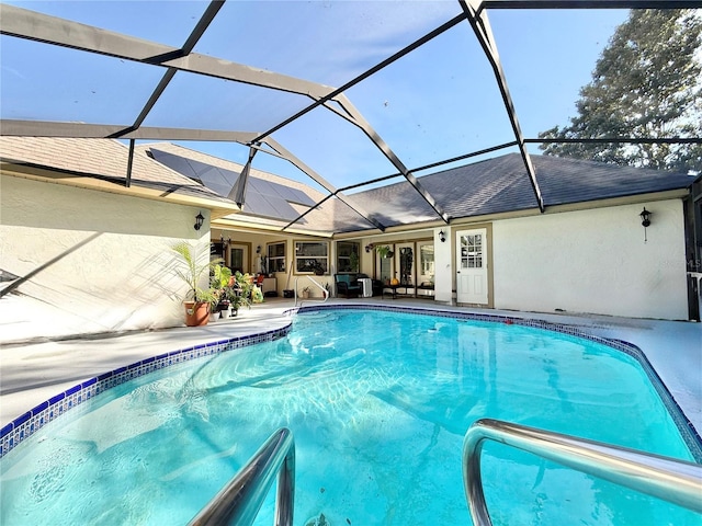 view of swimming pool featuring a lanai and a patio