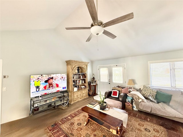 living room featuring hardwood / wood-style flooring, vaulted ceiling, and ceiling fan