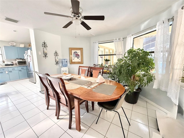 dining space with light tile patterned floors and ceiling fan