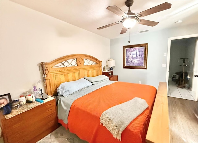 bedroom with ceiling fan and wood-type flooring