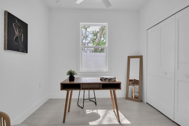 office space with light hardwood / wood-style floors and ceiling fan