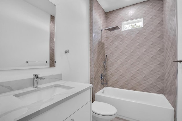 full bathroom with vanity, toilet, and tiled shower / bath