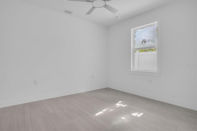 empty room with light hardwood / wood-style flooring and ceiling fan