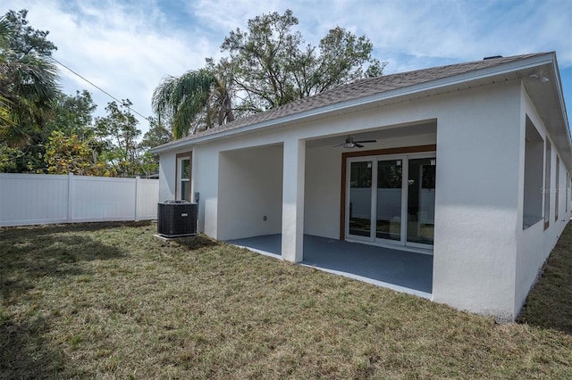 back of property featuring a yard, a patio area, ceiling fan, and central air condition unit