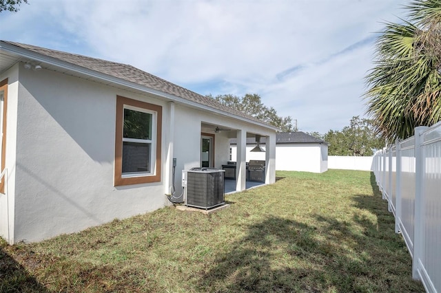 view of yard with a patio area and central air condition unit