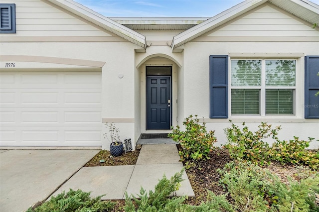 doorway to property with a garage