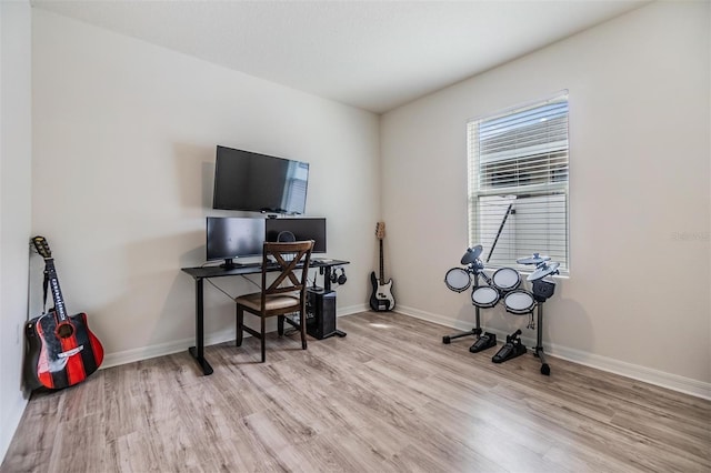 office space with baseboards and wood finished floors