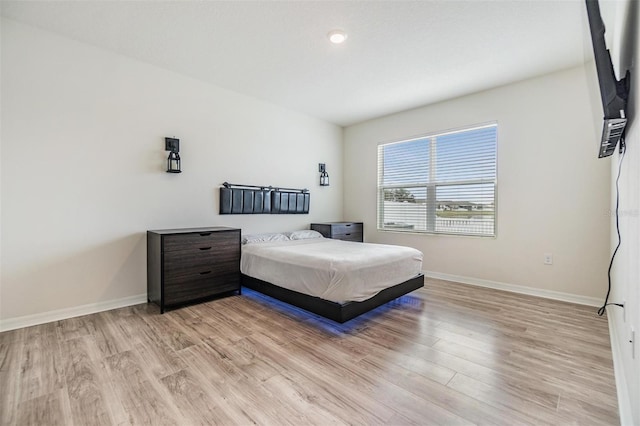 bedroom featuring light wood-style flooring and baseboards