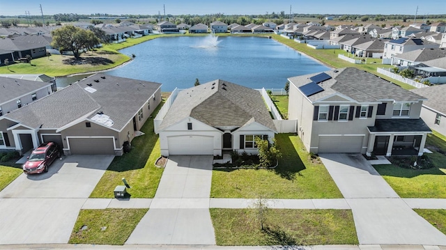 drone / aerial view featuring a residential view and a water view