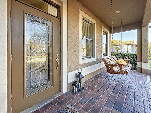 property entrance featuring covered porch