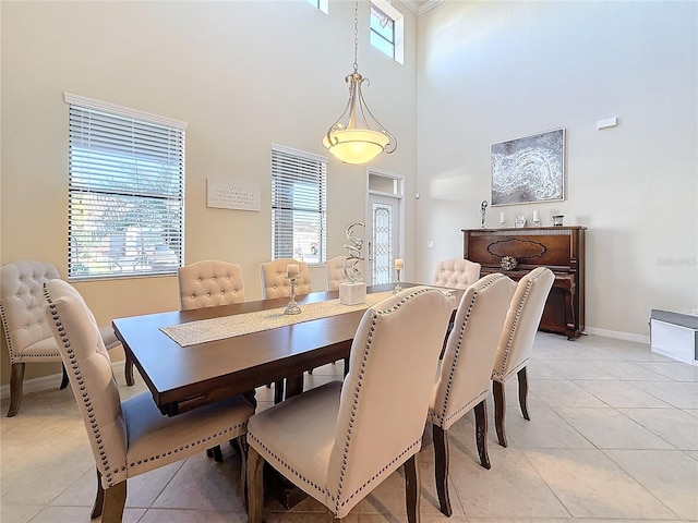 tiled dining area with a high ceiling