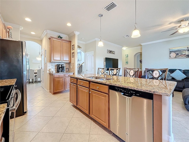 kitchen featuring stainless steel appliances, light stone countertops, a center island with sink, and light tile patterned floors