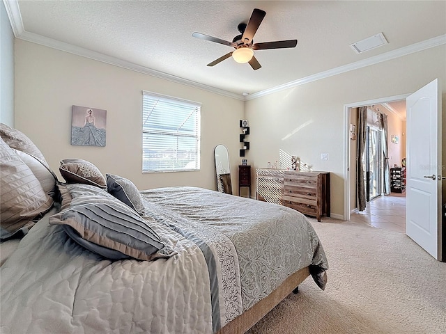 bedroom with light colored carpet, ornamental molding, and a textured ceiling