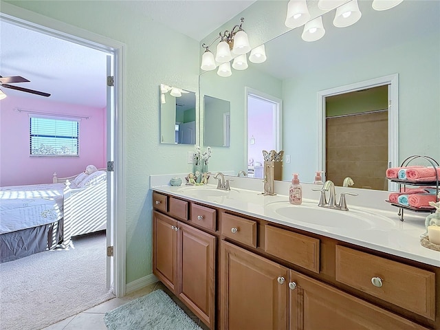 bathroom featuring tile patterned flooring, vanity, and ceiling fan