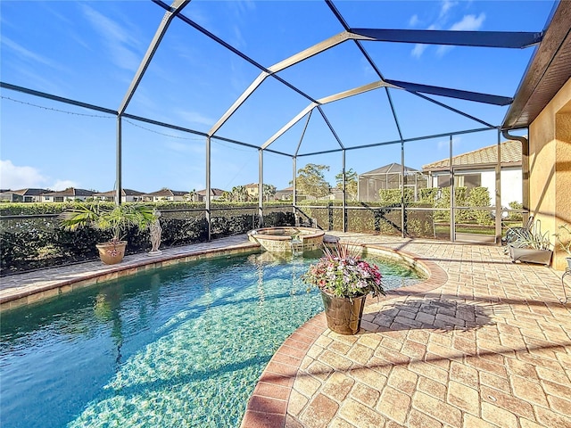 view of swimming pool featuring an in ground hot tub, a lanai, and a patio