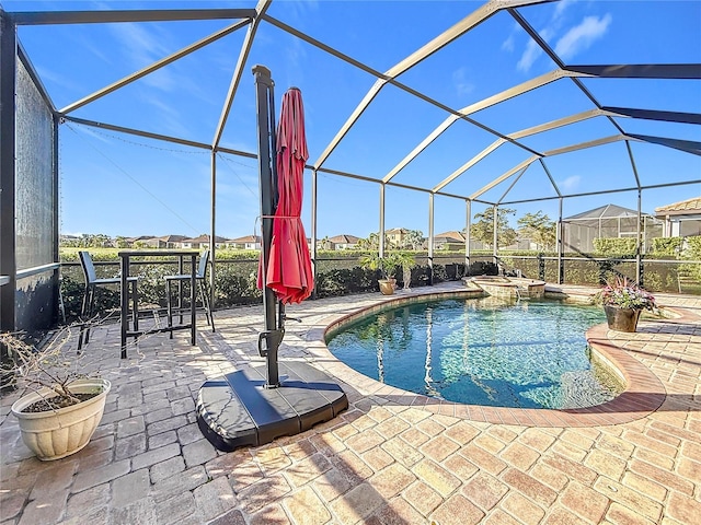 view of swimming pool with an in ground hot tub, a lanai, and a patio