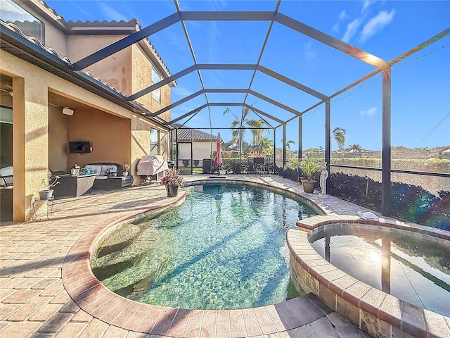 view of swimming pool with outdoor lounge area, a lanai, and a patio