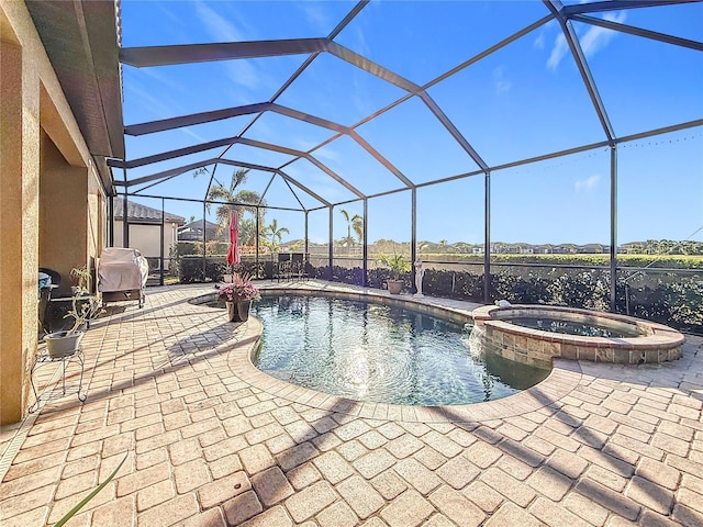 view of pool featuring an in ground hot tub, a lanai, and a patio