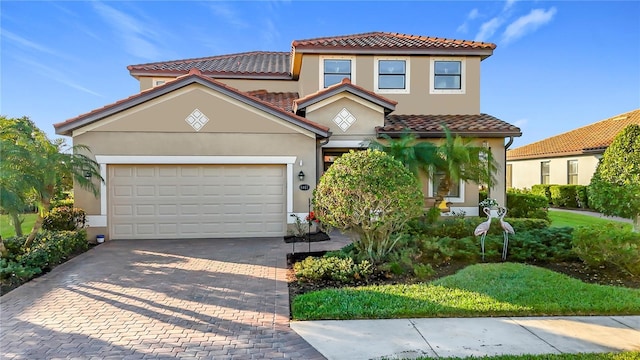 mediterranean / spanish-style home with a garage