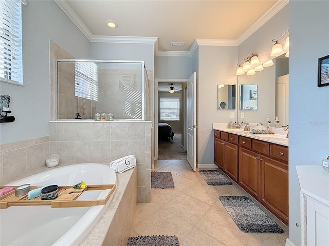 full bathroom featuring a stall shower, a bath, ornamental molding, double vanity, and tile patterned flooring
