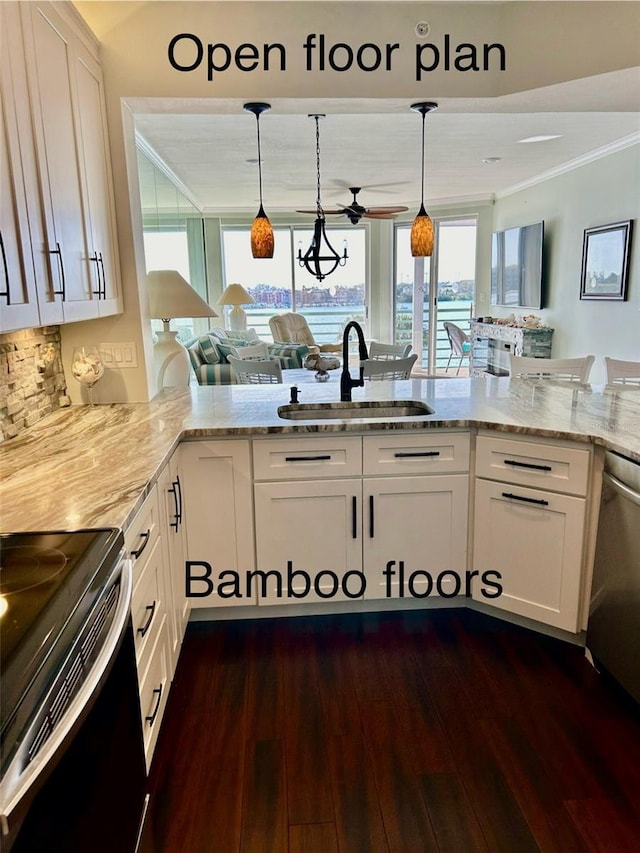 kitchen featuring sink, hanging light fixtures, kitchen peninsula, and white cabinets