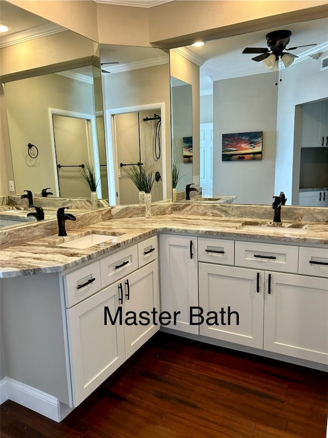 bathroom with vanity, hardwood / wood-style flooring, ornamental molding, and ceiling fan