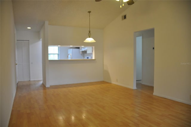 spare room featuring vaulted ceiling, ceiling fan, and hardwood / wood-style floors